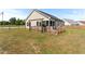 A nice backyard with a wood deck and fence under a blue sky at 50 Waterford Dr, Angier, NC 27501