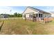 Exterior view of a home with a fenced-in yard, a back deck, and green grass at 50 Waterford Dr, Angier, NC 27501