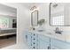 Stylish bathroom featuring double sinks with marble countertops and light blue cabinets near the bedroom at 50 Waterford Dr, Angier, NC 27501