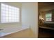 Bright bathroom with a large soaking tub next to Primary bedroom at 50 Waterford Dr, Angier, NC 27501