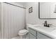 Well-lit bathroom featuring a vanity with countertop sink, black faucet, and a framed mirror at 50 Waterford Dr, Angier, NC 27501
