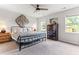 Bright bedroom featuring a black metal bed frame, neutral walls, and carpet floors with natural light at 50 Waterford Dr, Angier, NC 27501
