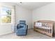 Cozy carpeted Bedroom featuring a crib, a comfy chair, and a bright window with a view at 50 Waterford Dr, Angier, NC 27501