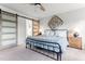 Bright bedroom featuring a black metal bed frame, neutral walls, carpet floors and a sliding barn door at 50 Waterford Dr, Angier, NC 27501