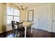 Cozy dining room featuring a rustic table, chandelier, and large window offering ample natural light at 50 Waterford Dr, Angier, NC 27501