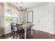 Cozy dining area featuring a rustic dining table with wooden chairs and ample natural light at 50 Waterford Dr, Angier, NC 27501