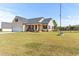 Exterior view of the home with a long yard and fence at 50 Waterford Dr, Angier, NC 27501