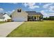 Charming single-story home with a well-manicured lawn, a two-car garage and inviting front porch at 50 Waterford Dr, Angier, NC 27501