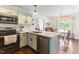 Beautifully renovated kitchen showcasing stainless steel appliances and an open view to the dining area at 50 Waterford Dr, Angier, NC 27501
