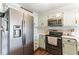 Well-equipped kitchen with stainless steel appliances and light green cabinetry at 50 Waterford Dr, Angier, NC 27501