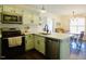 Modern kitchen with stainless steel appliances, light green cabinets and dining area in view at 50 Waterford Dr, Angier, NC 27501