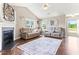Spacious living room with hardwood floors, fireplace, and two sofas under natural lighting at 50 Waterford Dr, Angier, NC 27501