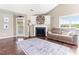Comfortable living room with a cozy fireplace, complemented by hardwood floors and natural light from the large window at 50 Waterford Dr, Angier, NC 27501