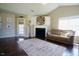 Bright living room with fireplace, hardwood floors, and a neutral-colored sofa underneath a vaulted ceiling at 50 Waterford Dr, Angier, NC 27501