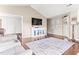 A bright living room is showcased with hardwood floors and a white cabinet under a television at 50 Waterford Dr, Angier, NC 27501