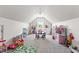 Spacious playroom with sloped ceilings, a large window, and furniture at 50 Waterford Dr, Angier, NC 27501