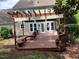 Outdoor deck features a pergola, seating, and access to the backyard at 501 Samara St, Apex, NC 27502