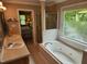 Bright bathroom with double sinks, soaking tub, and glass-enclosed shower at 501 Samara St, Apex, NC 27502