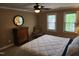 This bedroom features a ceiling fan, natural light, a mirror and neutral walls at 501 Samara St, Apex, NC 27502