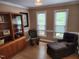 Inviting living room with natural light, featuring wood floors, a hutch and comfortable seating at 501 Samara St, Apex, NC 27502