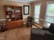 Comfortable sitting area boasts natural light, rocking chair, and display cabinet at 501 Samara St, Apex, NC 27502