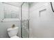 Bathroom featuring a glass shower door, window and white tiling at 503 Gooseneck Drive # B4, Cary, NC 27513