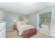 Comfortable bedroom with a cozy bed, decorative mirror, natural light, and side tables at 503 Gooseneck Drive # B4, Cary, NC 27513