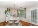 Well-lit dining area with a round table, modern chairs, stylish decor, and access to the outside at 503 Gooseneck Drive # B4, Cary, NC 27513