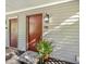Condo front door with lovely potted plants, an exterior light, and the unit number B-4 at 503 Gooseneck Drive # B4, Cary, NC 27513