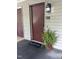 Condo exterior featuring a welcoming entryway with a welcome mat and potted fern at 503 Gooseneck Drive # B4, Cary, NC 27513