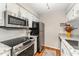 Modern kitchen with stainless steel appliances, granite countertops, and white cabinets at 503 Gooseneck Drive # B4, Cary, NC 27513