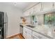 Bright kitchen featuring stainless steel appliances, white cabinets, and granite countertops at 503 Gooseneck Drive # B4, Cary, NC 27513