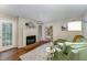 The living room has a fireplace, green couch, and a bookcase with books, plants, and decorations at 503 Gooseneck Drive # B4, Cary, NC 27513