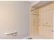 Bathroom features a accessible walk-in shower with grab bars and tile surround at 600 Audubon Lake Dr # 6B13, Durham, NC 27713