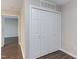 A view of a hallway with a closet and updated laminate flooring at 600 Audubon Lake Dr # 6B13, Durham, NC 27713