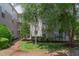 Exterior view of the building with lush green trees and landscape lighting at 600 Audubon Lake Dr # 6B13, Durham, NC 27713