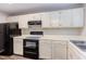 Well-lit kitchen featuring white cabinets, modern appliances and laminate countertops at 600 Audubon Lake Dr # 6B13, Durham, NC 27713