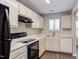 An updated kitchen with white cabinets and modern appliances at 600 Audubon Lake Dr # 6B13, Durham, NC 27713