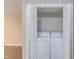 Open laundry closet with white washer and dryer and bi-fold doors at 600 Audubon Lake Dr # 6B13, Durham, NC 27713