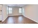 Bright living room with updated flooring, two windows, and sliding glass doors to a patio at 600 Audubon Lake Dr # 6B13, Durham, NC 27713