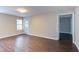 Spacious living room with updated flooring, neutral paint, and access to a private patio at 600 Audubon Lake Dr # 6B13, Durham, NC 27713