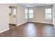 Living room showcasing flooring updates and view to kitchen and sunlit windows at 600 Audubon Lake Dr # 6B13, Durham, NC 27713