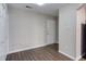 A view of a modern living room with hardwood floors and neutral walls at 600 Audubon Lake Dr # 6B13, Durham, NC 27713