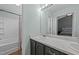 Well-lit bathroom featuring double sinks, modern lighting, and a shower-tub combination at 609 Woodson Dr, Clayton, NC 27527
