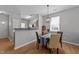Cozy dining area with a modern chandelier, window views, and an open floor plan to the kitchen for easy entertaining at 609 Woodson Dr, Clayton, NC 27527