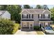 Charming two-story home with a well-manicured lawn, a covered front porch, and lovely curb appeal at 609 Woodson Dr, Clayton, NC 27527