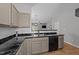 Contemporary kitchen featuring stainless steel appliances, sleek granite countertops, ample cabinetry, and stylish flooring at 609 Woodson Dr, Clayton, NC 27527