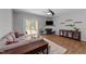 Cozy living room with a ceiling fan, stylish fireplace, sliding doors to the deck and comfortable seating for relaxing at 609 Woodson Dr, Clayton, NC 27527