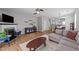 Cozy living room featuring a fireplace, stylish decor, and a seamless transition into the dining area at 609 Woodson Dr, Clayton, NC 27527