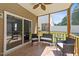 Cozy screened porch with tile flooring and comfortable seating for outdoor relaxation at 609 Woodson Dr, Clayton, NC 27527